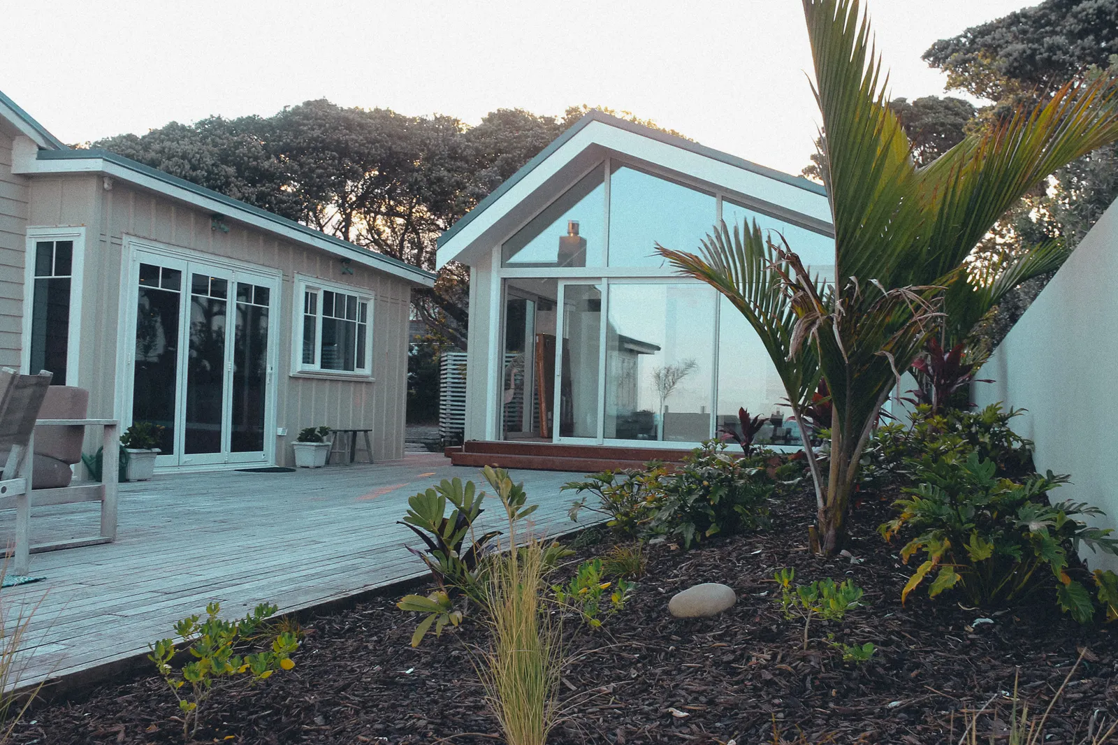 Timber deck and native planting beside a coastal home
